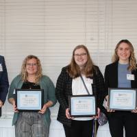 Faculty standing with their awards